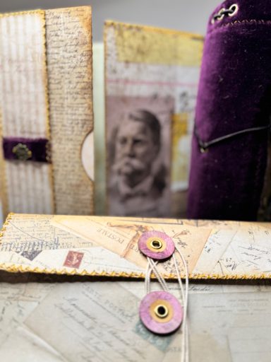 Journal "Maud Undone" - Detail View Handmade junk journal "Maud Undone" with string closure, vintage portrait and purple accents, Golden Spine Studio.